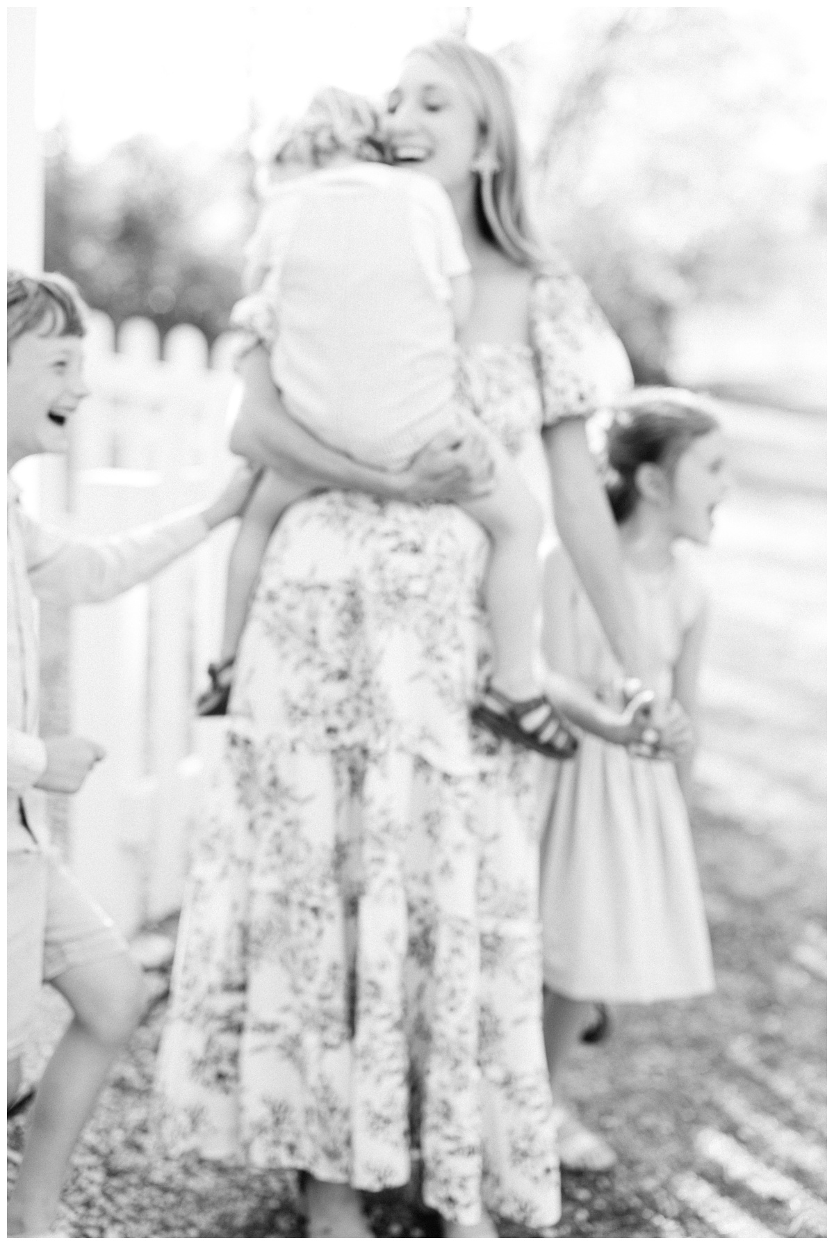 pregnant mom outside and joyful with her three children with excitement for their tulsa baby on the way