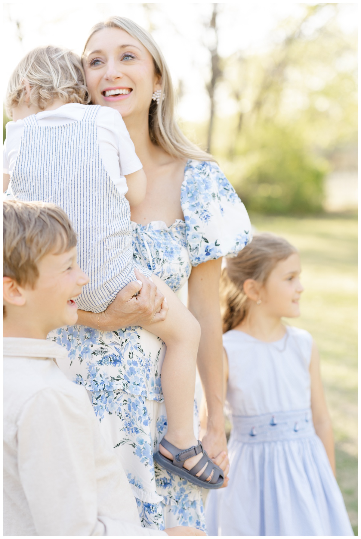 mom smiling with her three children for maternity portraits with Caroline Eidson