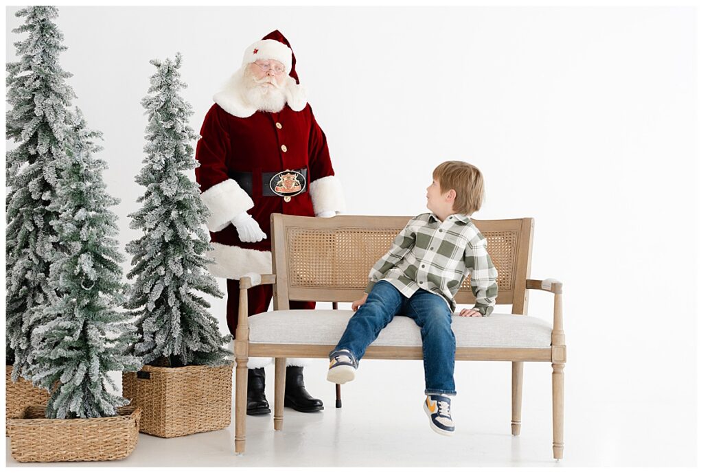 Young boy looking back at Santa during a private Santa photo session in Tulsa