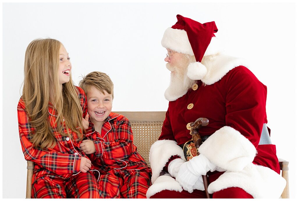 Brother and sister laughing with Santa during a private Tulsa Santa mini sessions